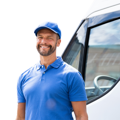 A smiling contractor standing in front of a kitchen cabinet delivery truck.